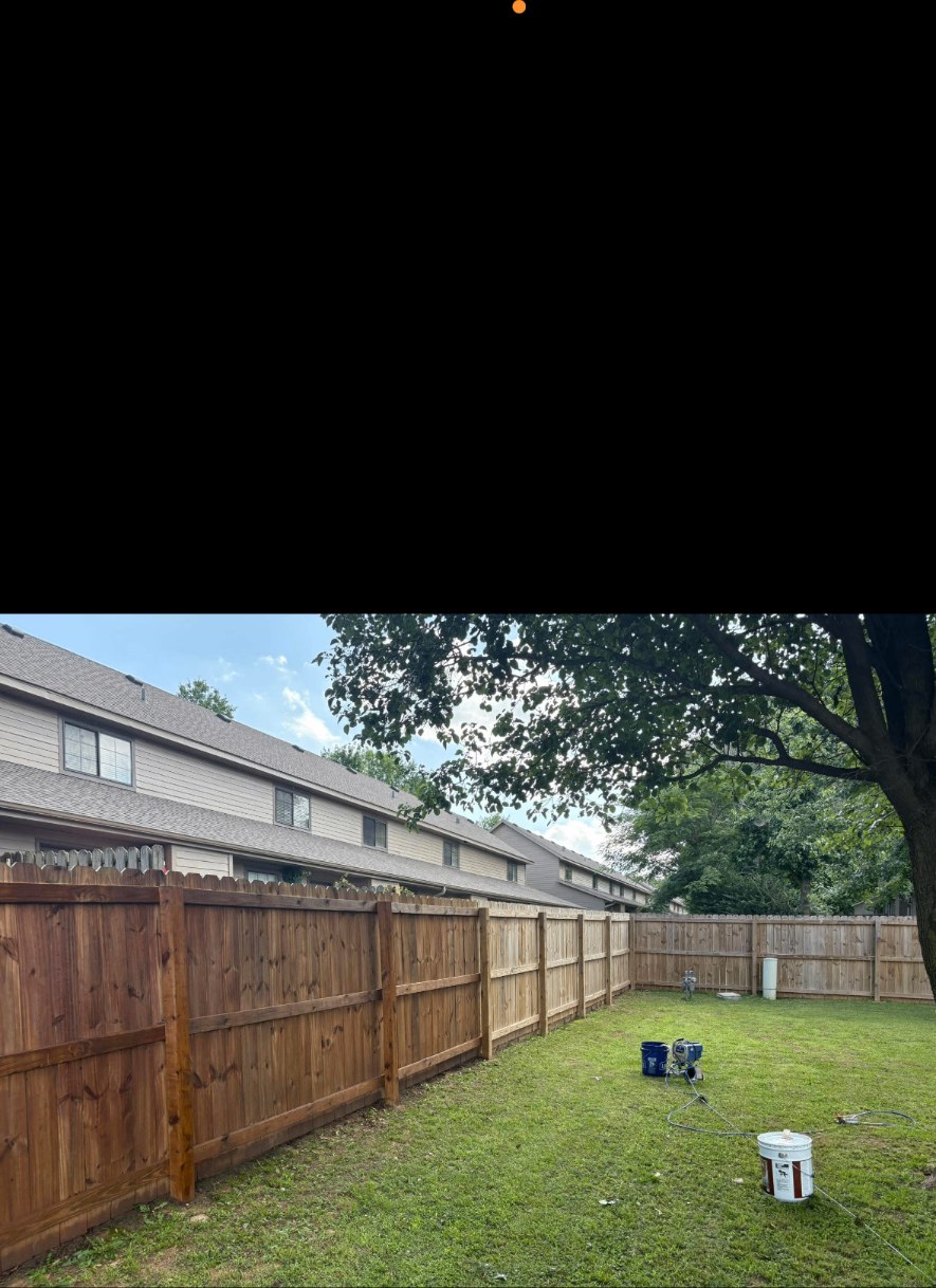 Finished fence staining by APEX Construction & Landscaping