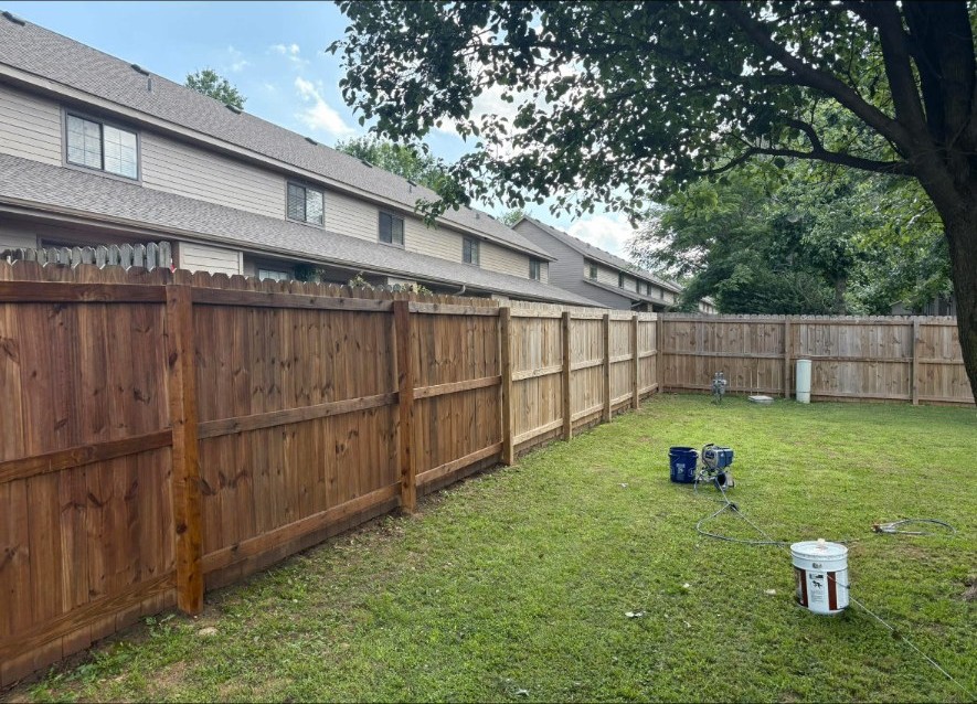 Finished fence staining by APEX Construction & Landscaping