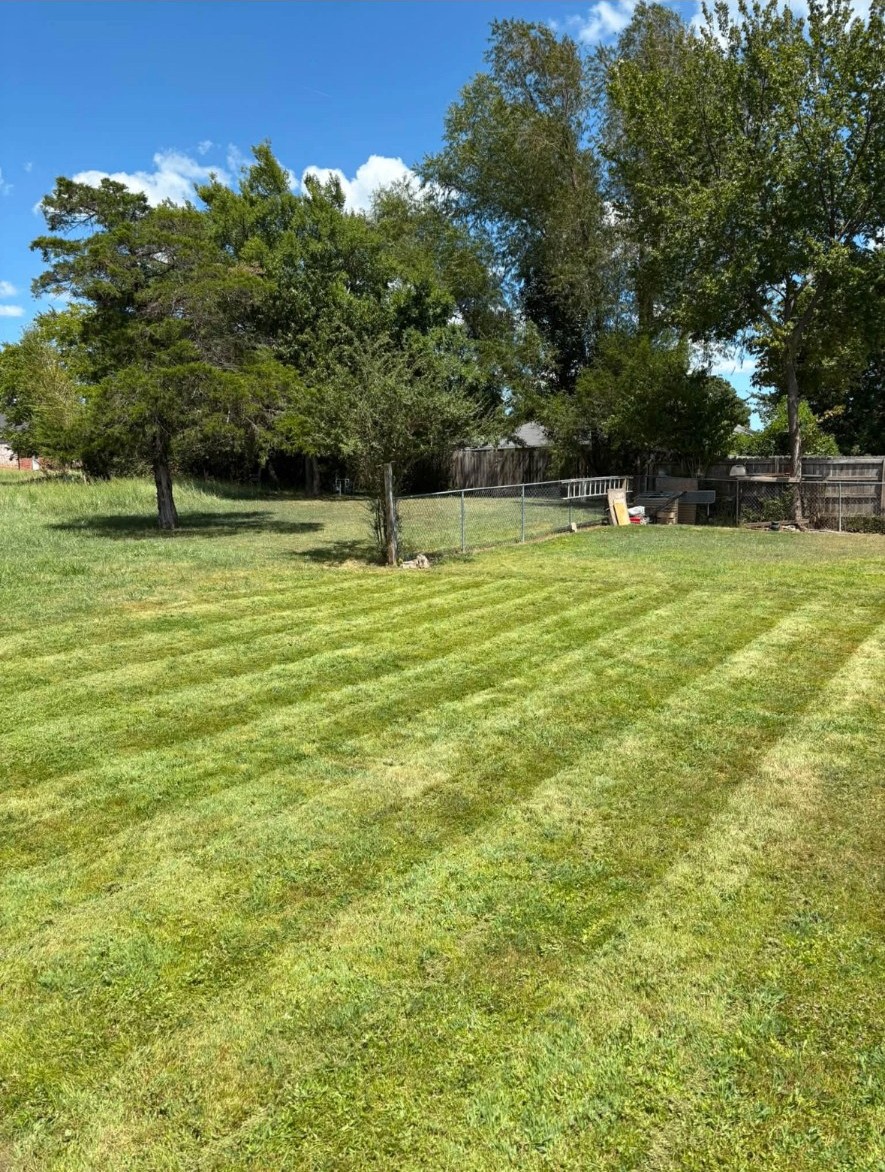 Finished lawn care & striping by APEX Construction & Landscaping